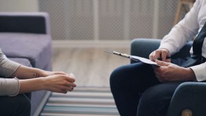 2 people sitting on a couch illustrating article on - EFT -Should you be friends with your clients?